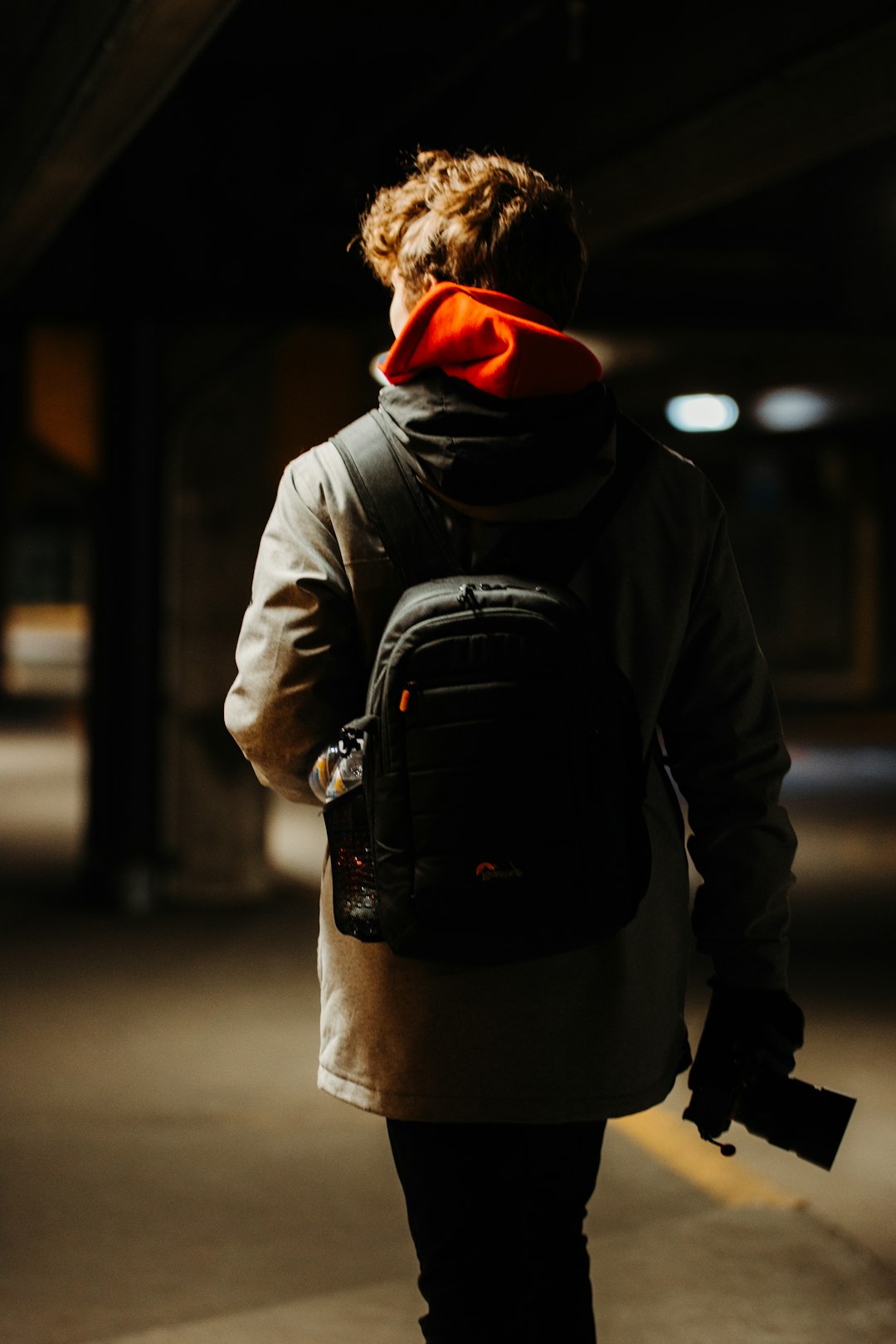 person in black hoodie wearing black backpack