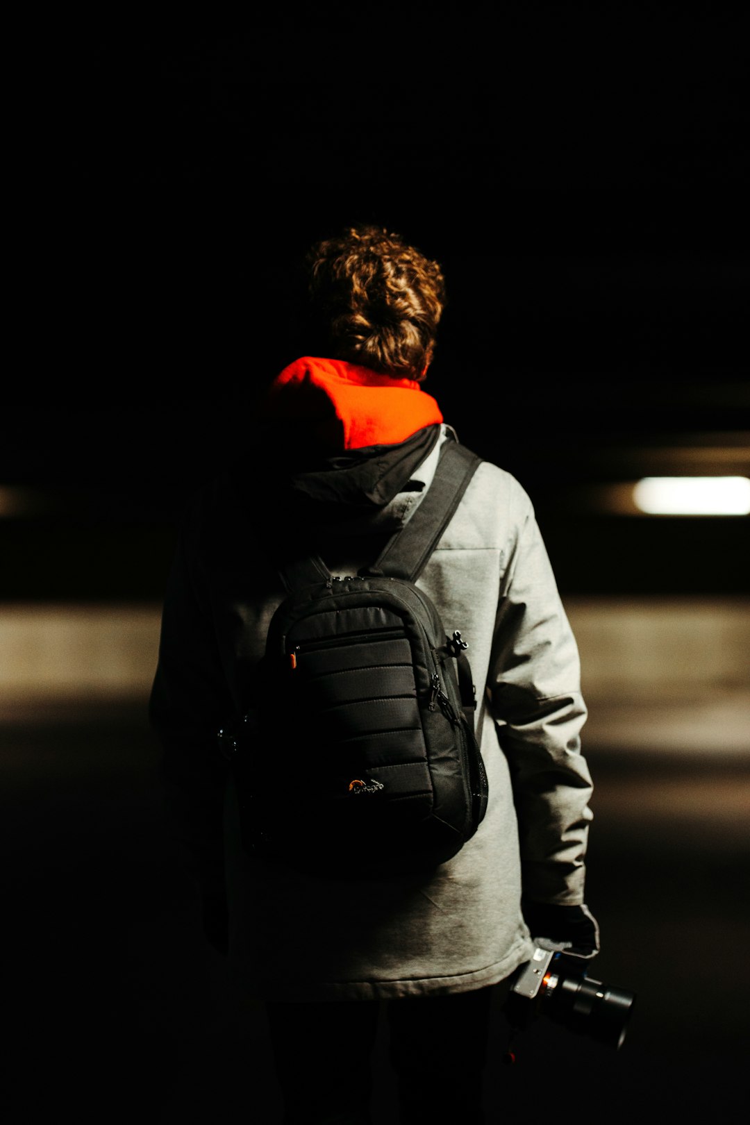 man in gray jacket and black backpack