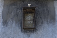 An old photograph pinned to a corkboard with yellow police tape framing the edges.