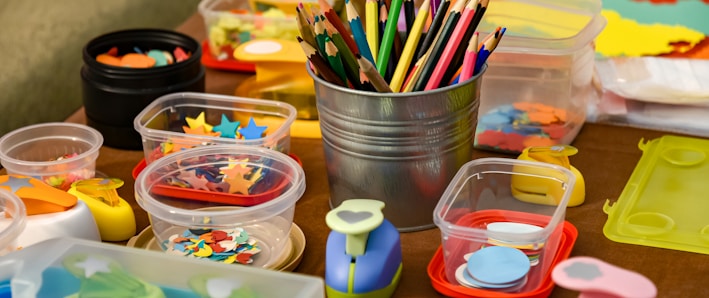 assorted color pencils in clear plastic container