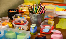 assorted color pencils in clear plastic container