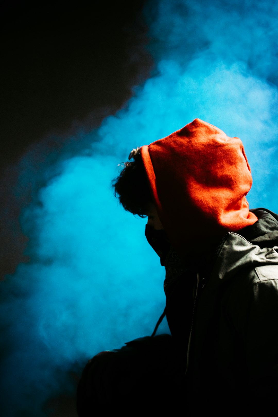 man in black jacket with red knit cap