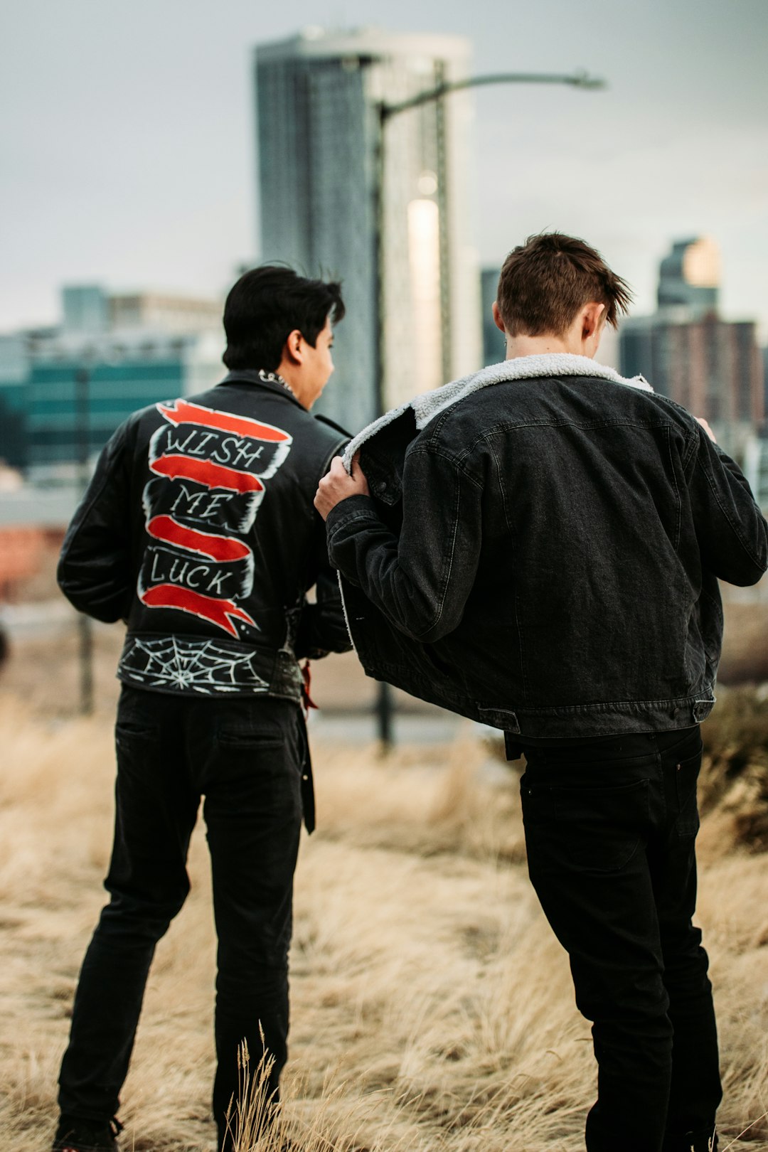 man in black jacket standing beside man in black jacket