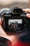 person holding black dslr camera