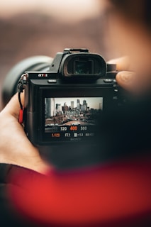 person holding black nikon dslr camera