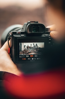 person holding black nikon dslr camera