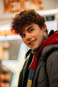 man in black and red jacket smiling