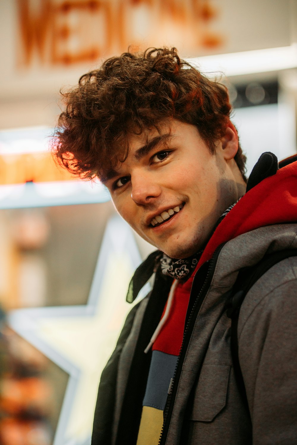 man in black and red jacket smiling