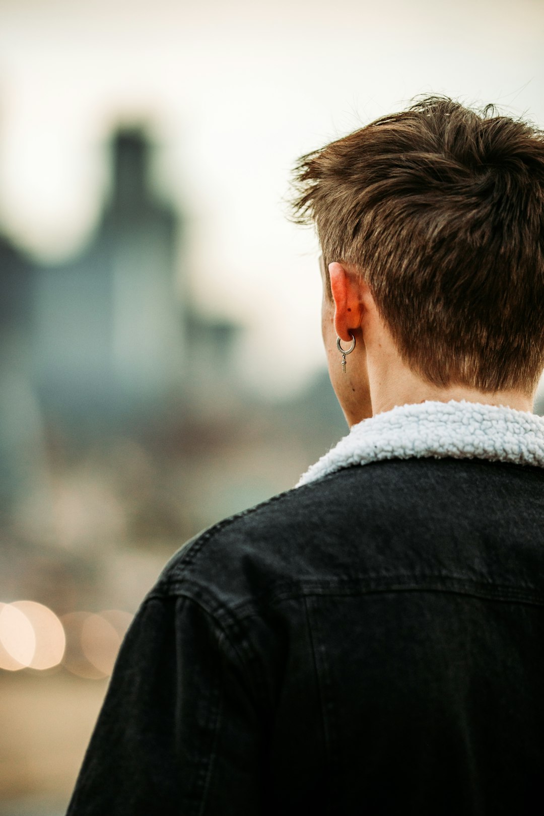 man in black jacket looking down