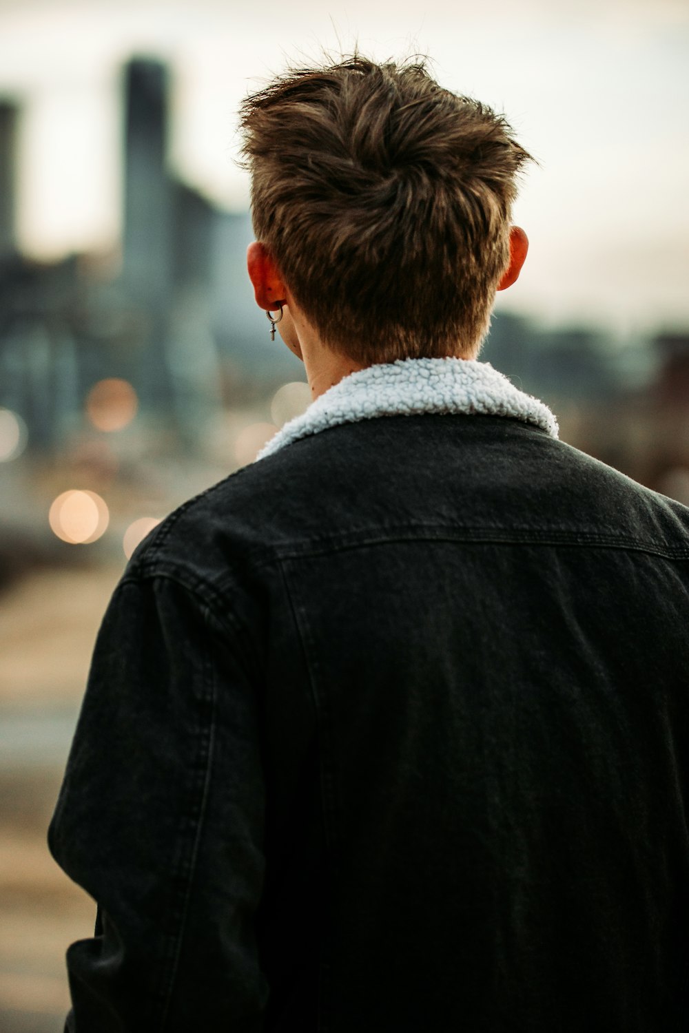 man in black jacket looking at the sky during daytime