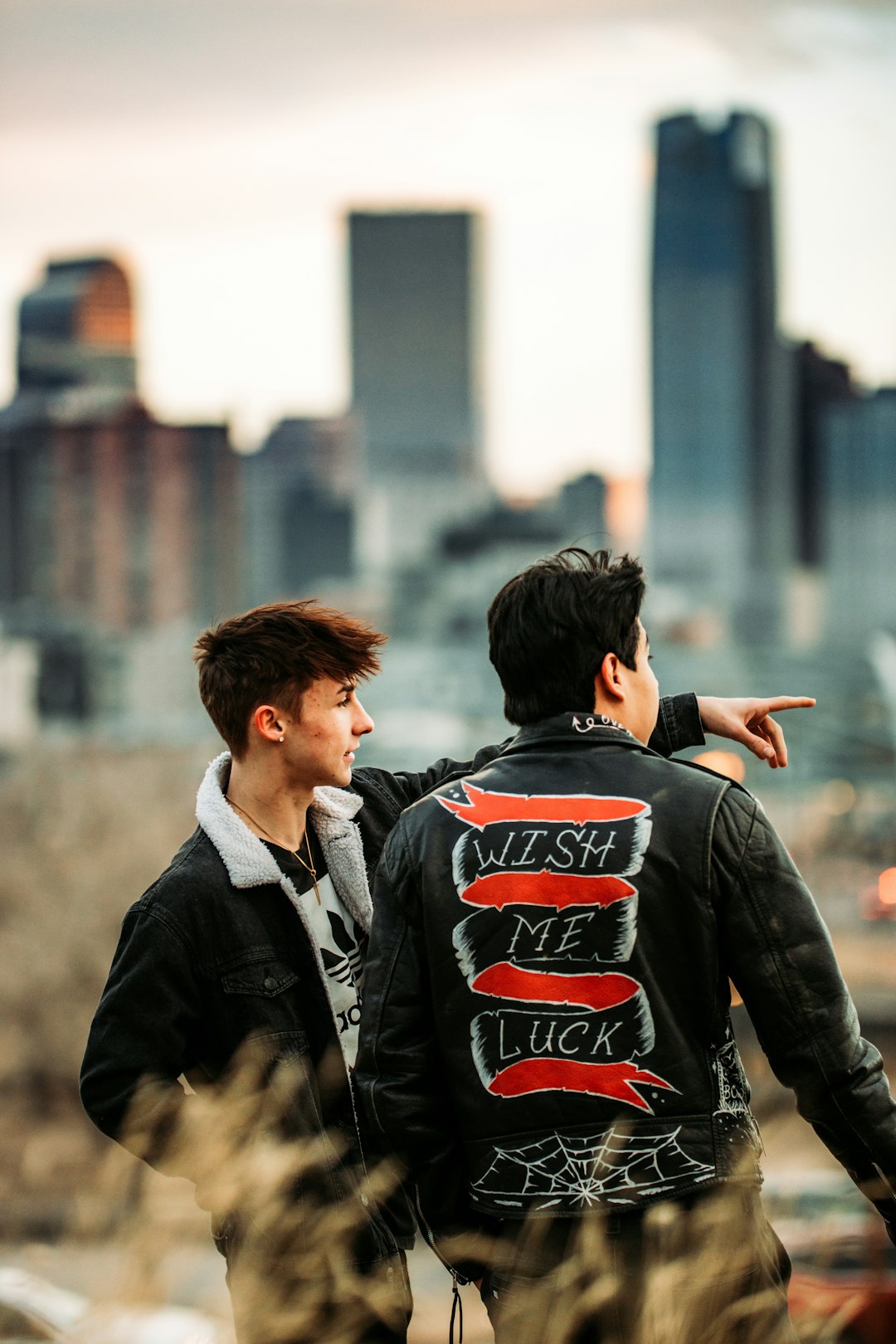 man in black leather jacket standing beside woman in black jacket