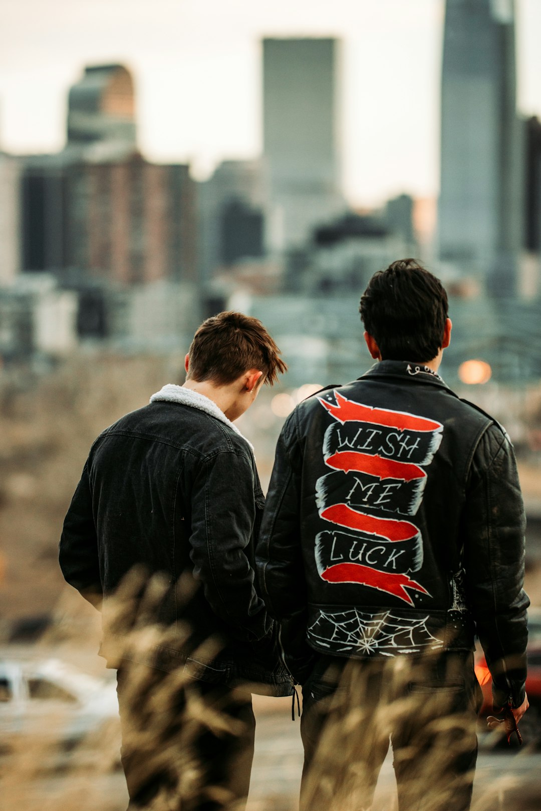 man in black jacket standing beside man in black jacket