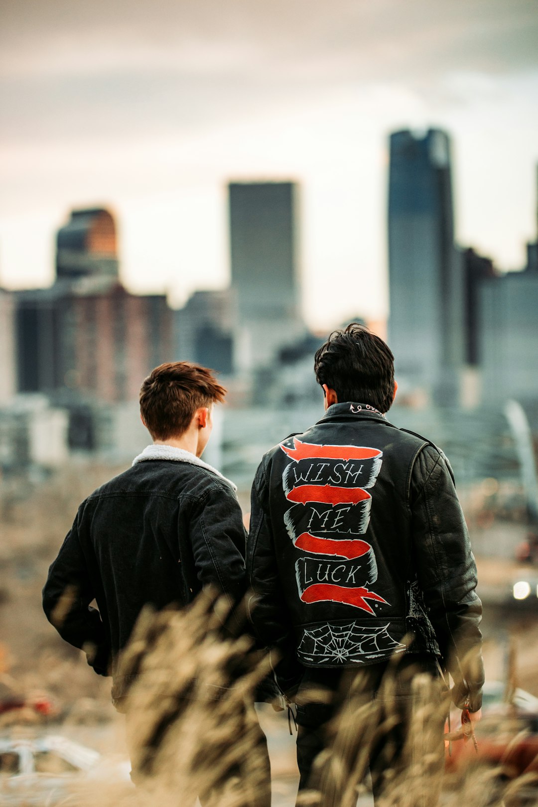 man in black jacket standing beside man in black jacket