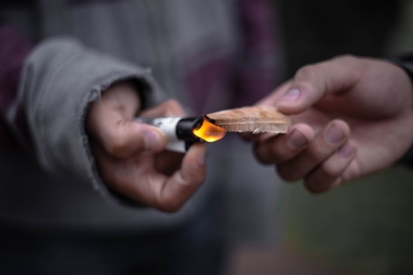 A beginner happily practicing wood-burning with the e-book open nearby.