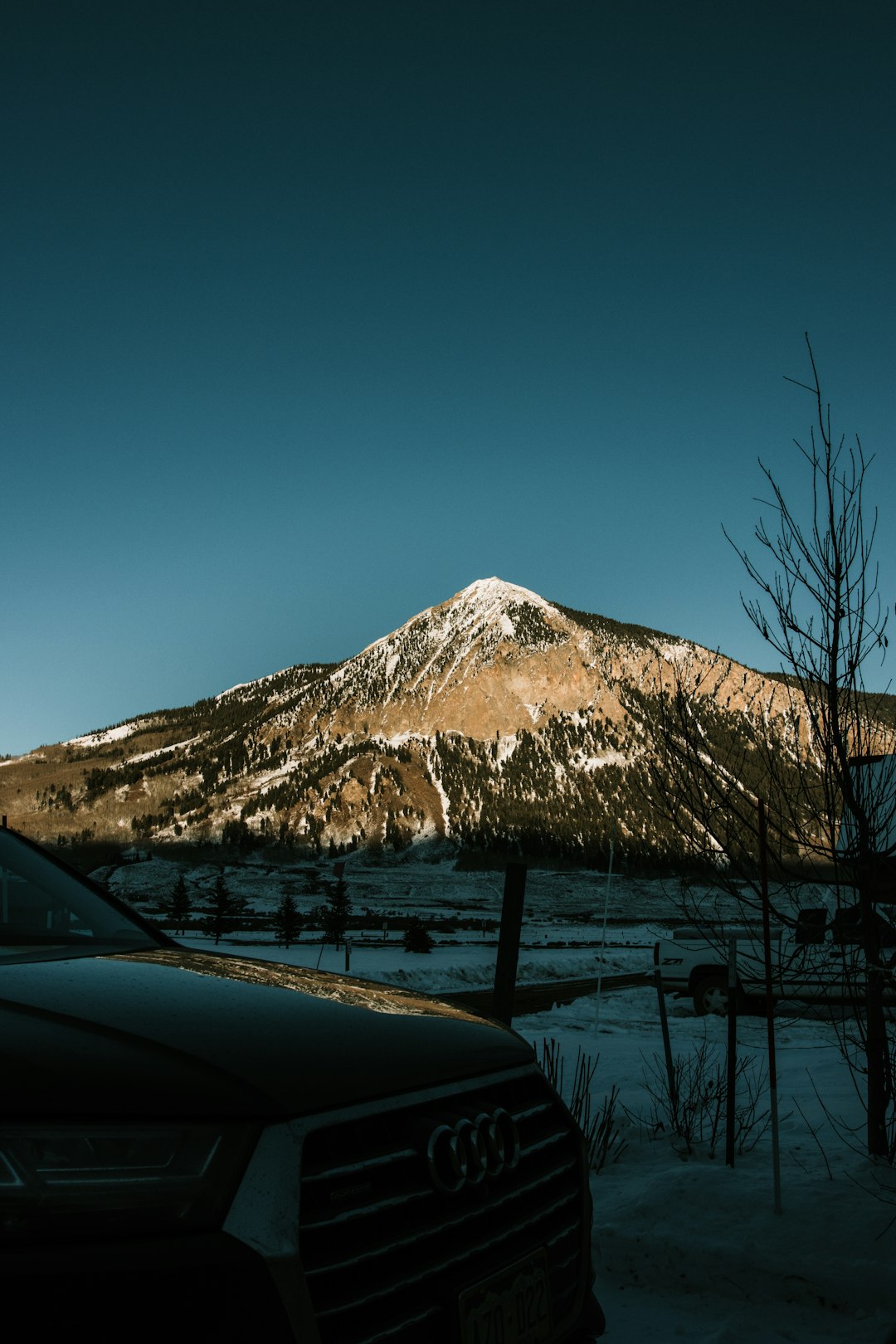 black car near snow covered mountain during daytime