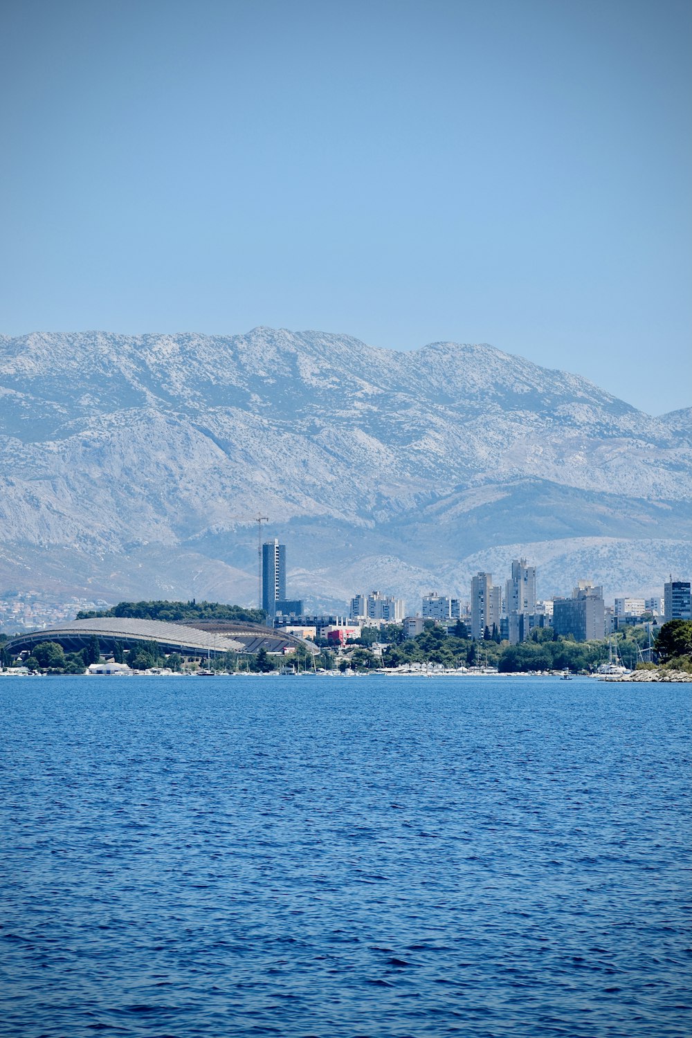 body of water near mountain during daytime