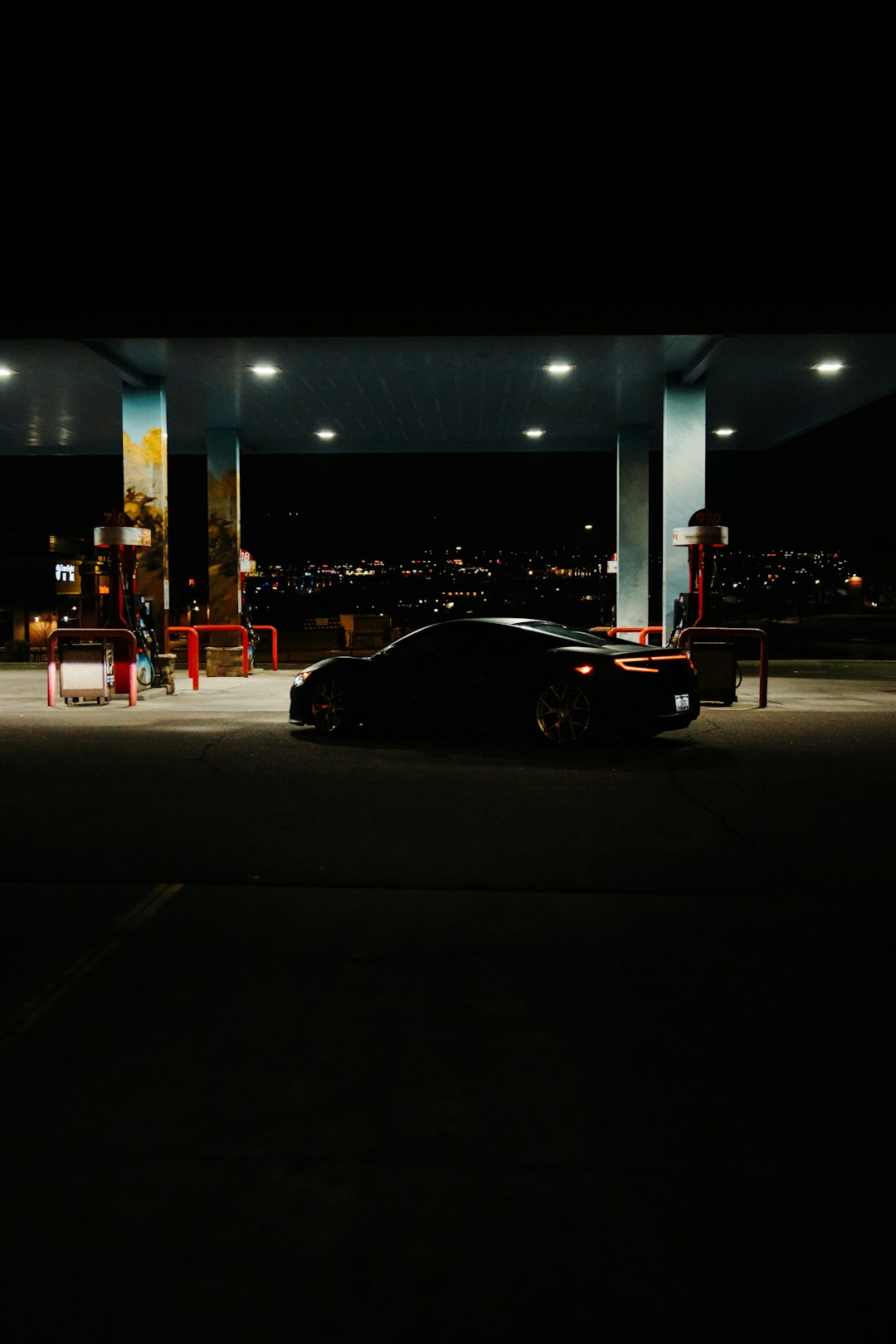 black coupe on road during night time