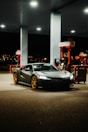 black porsche 911 parked in front of white and red building