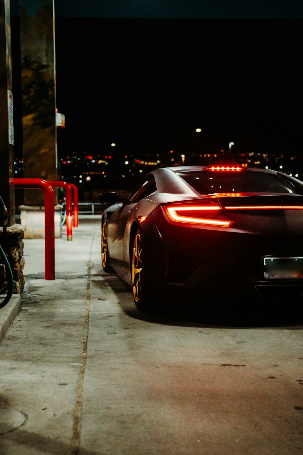 black porsche 911 parked on sidewalk during night time