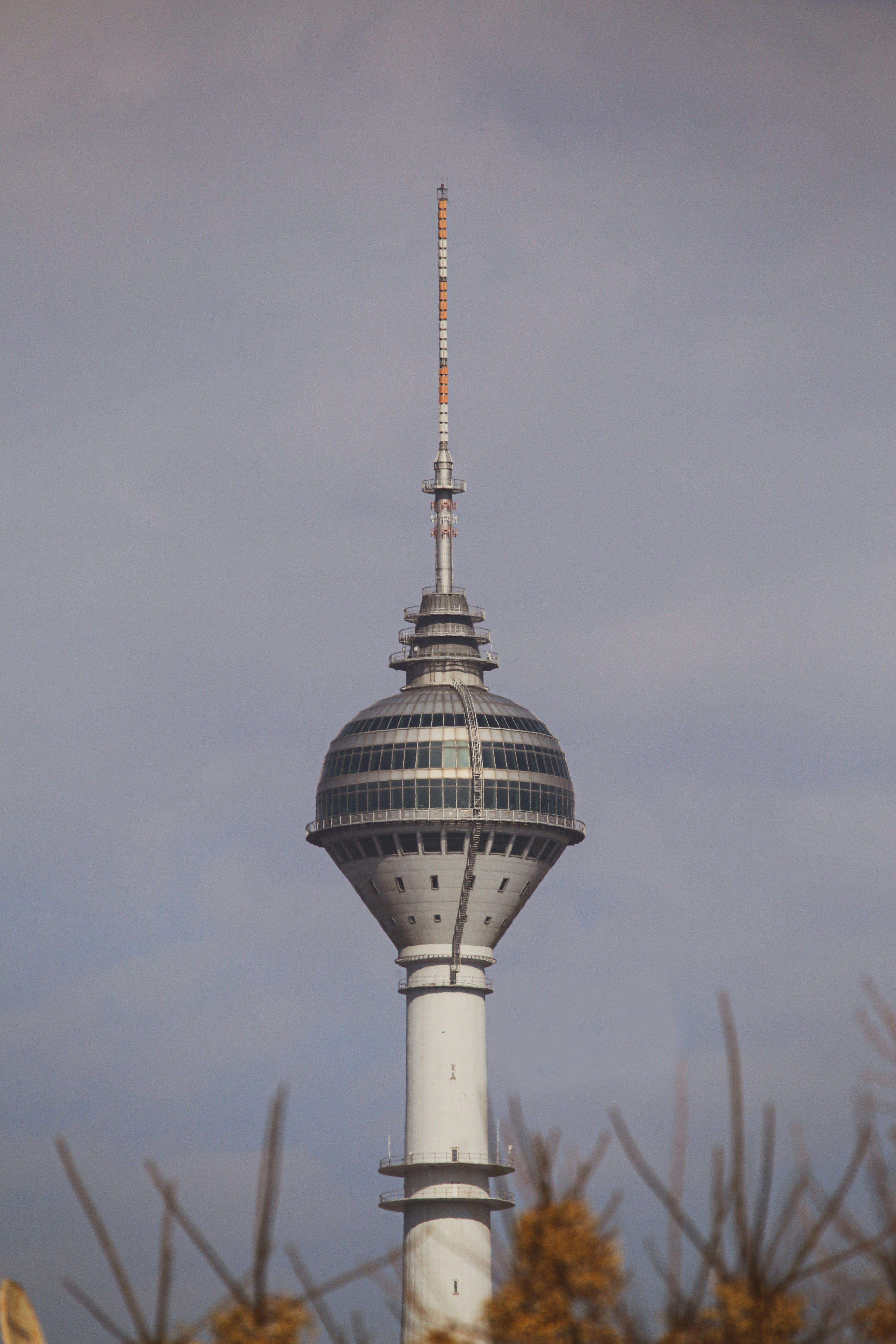 white and black tower under gray sky