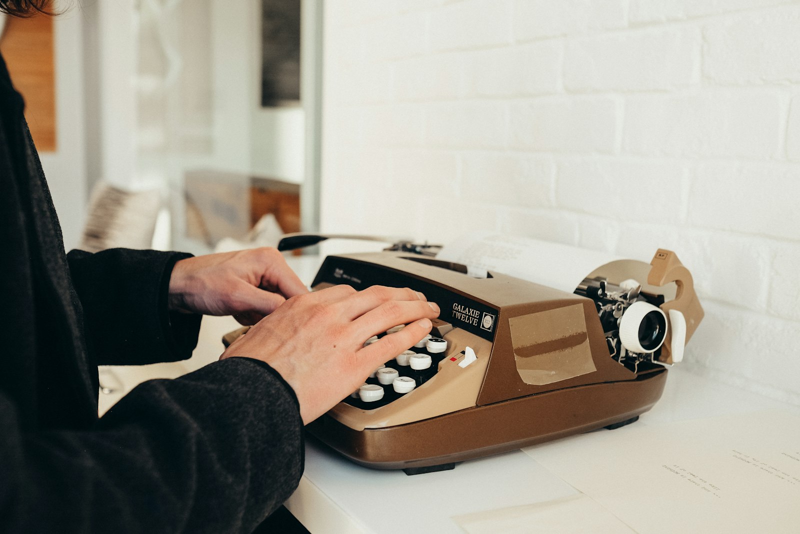 Person typing on typewriter