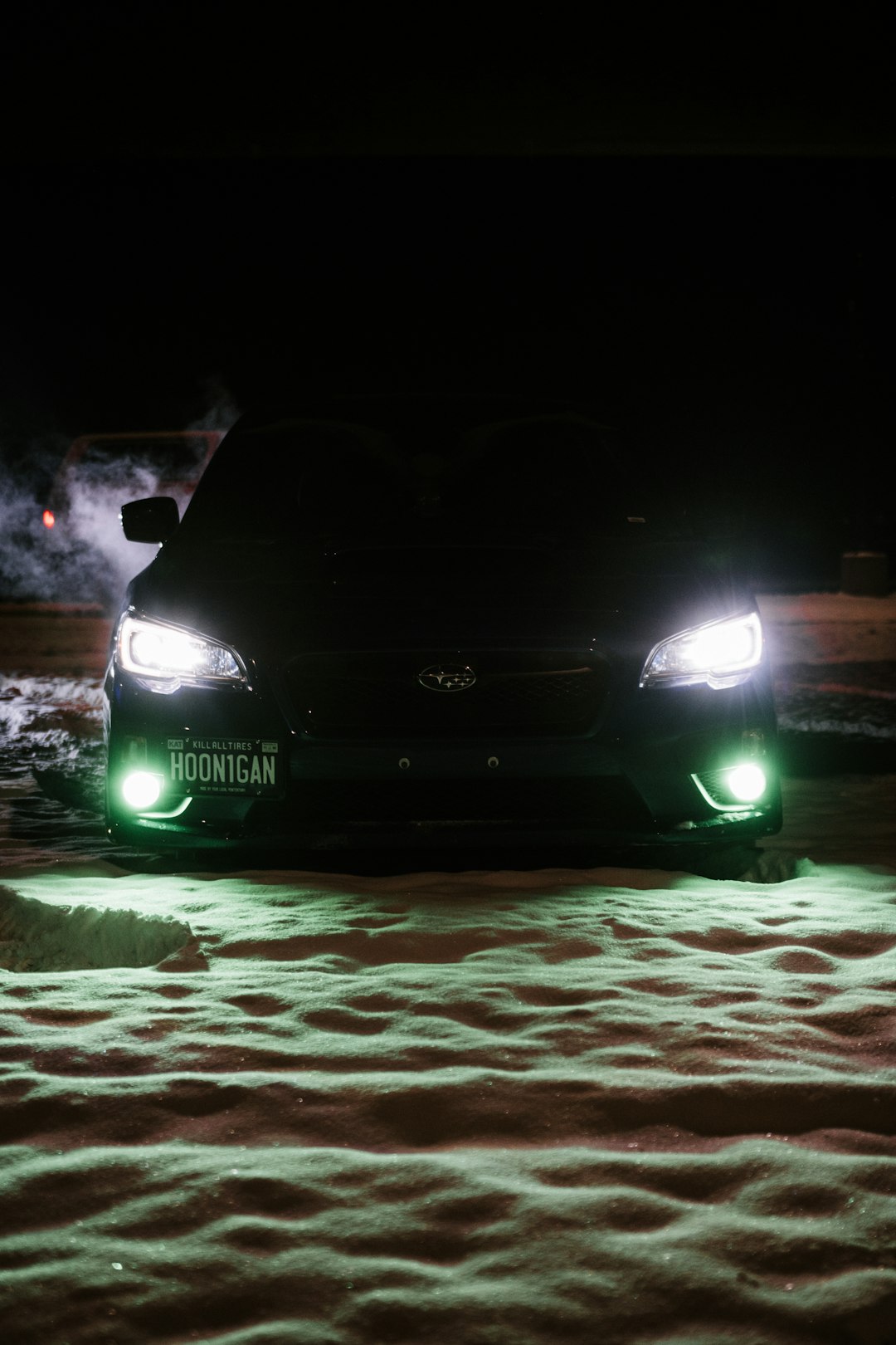 black car on road during night time