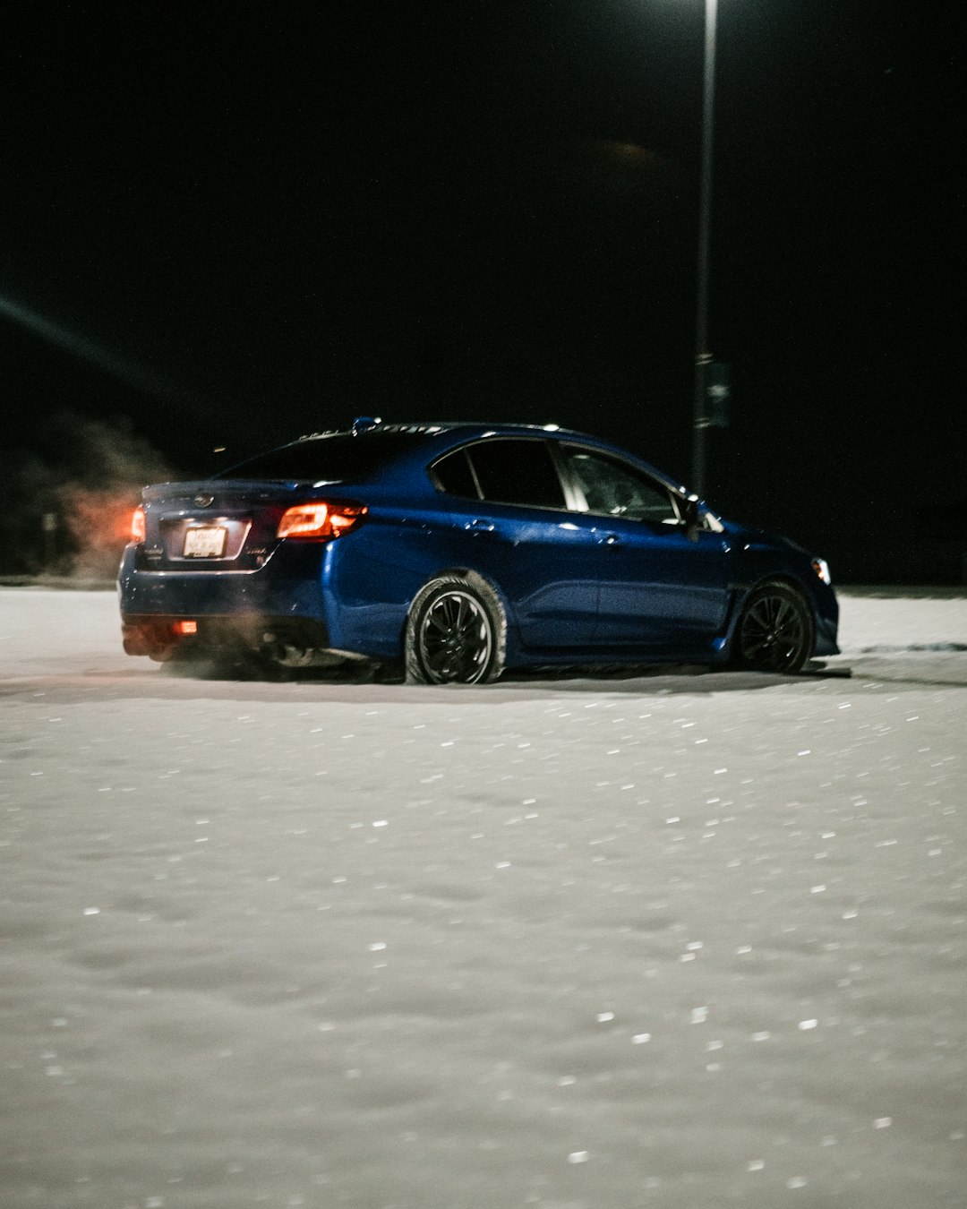 blue sedan on road during daytime