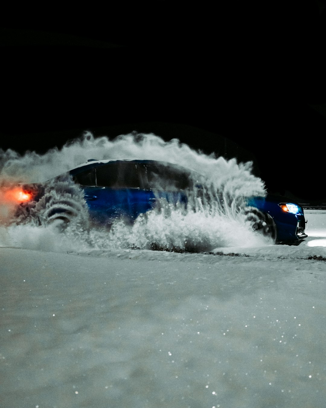 blue car on snow covered ground