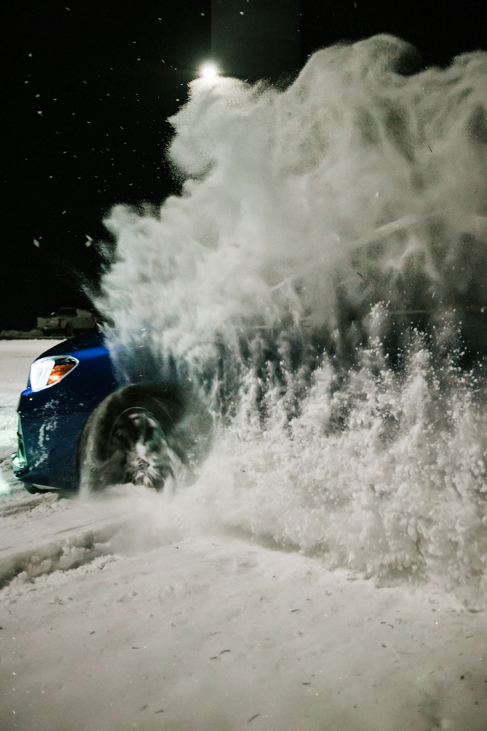 blue car on snow covered road during daytime