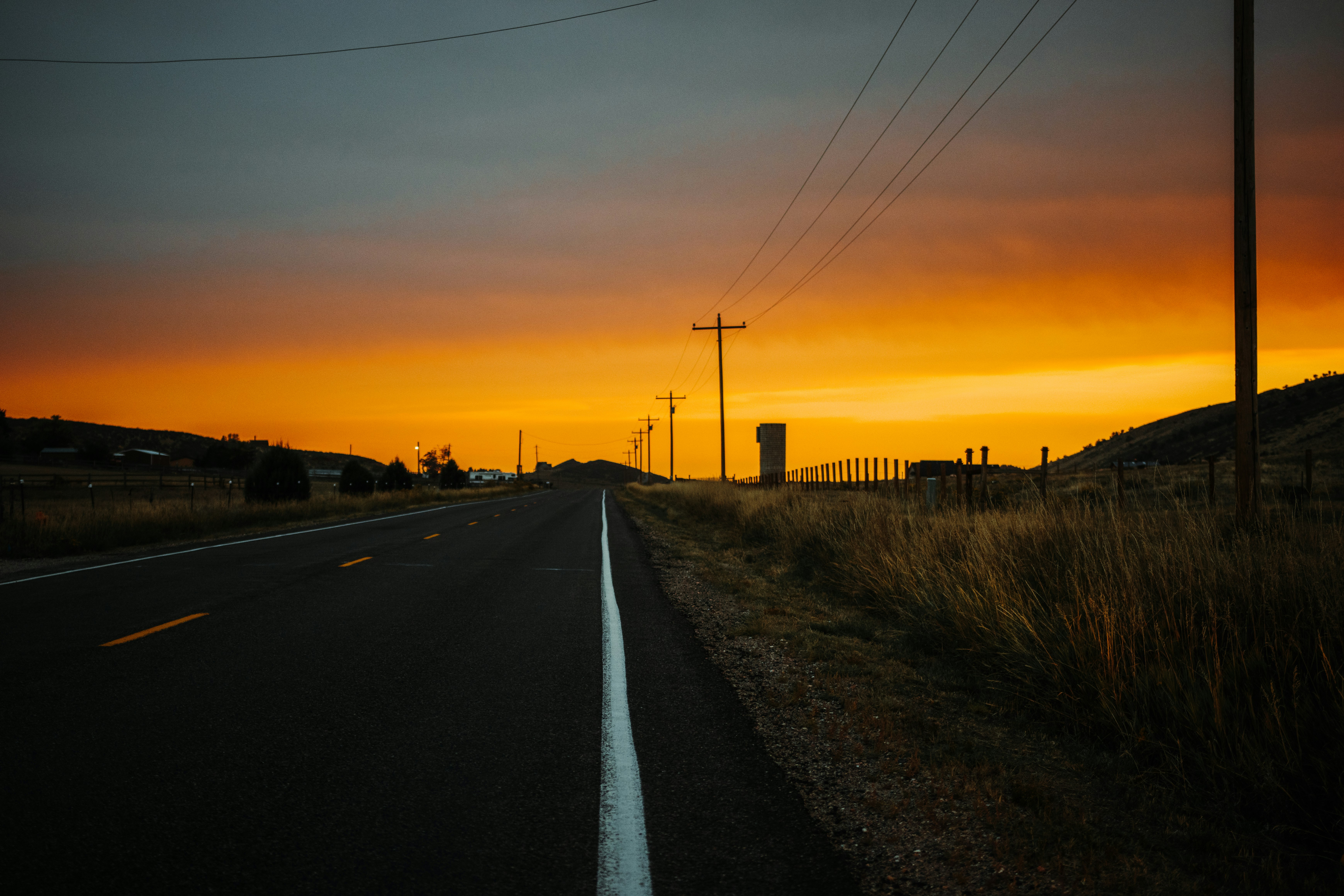 black car on road during sunset