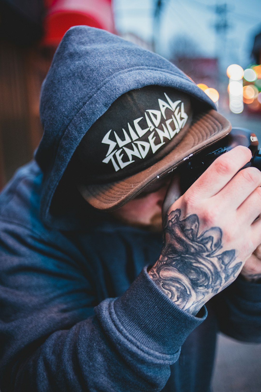 man in black and white cap and blue denim jacket