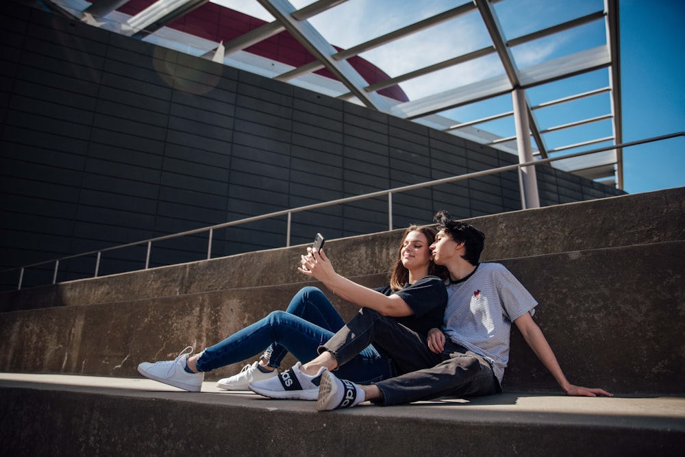 2 women sitting on concrete bench