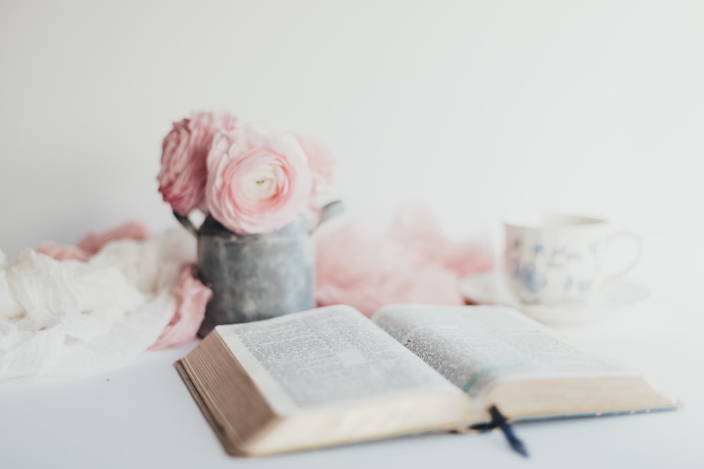 pink rose in gray ceramic vase on white table