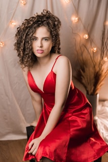 woman in red spaghetti strap dress