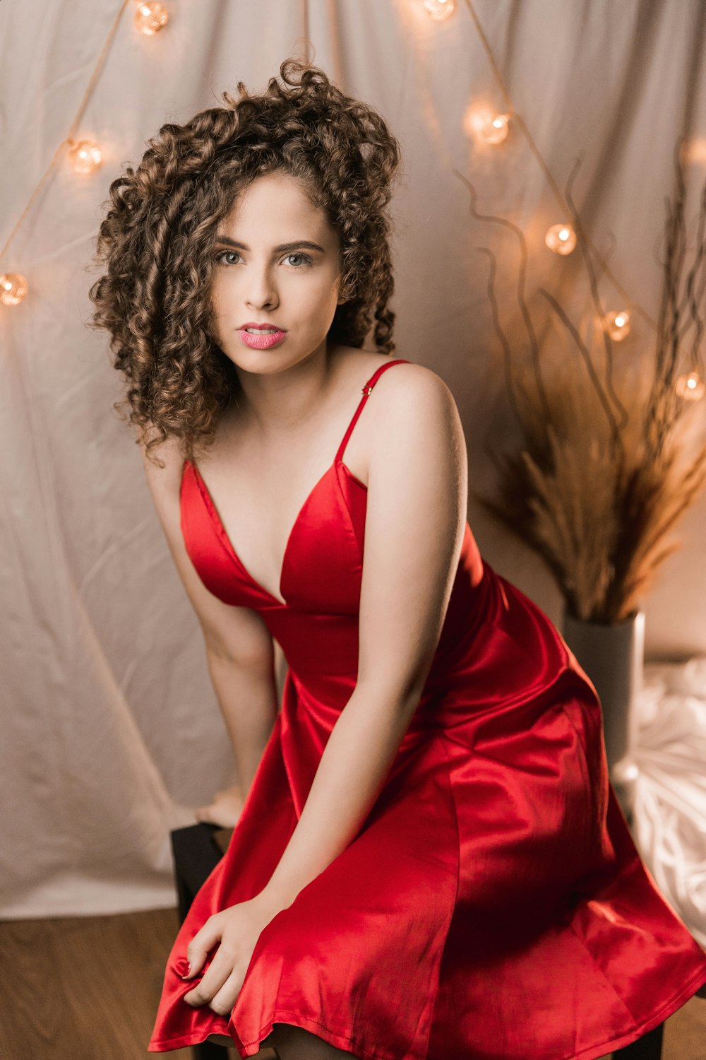 woman in red spaghetti strap dress