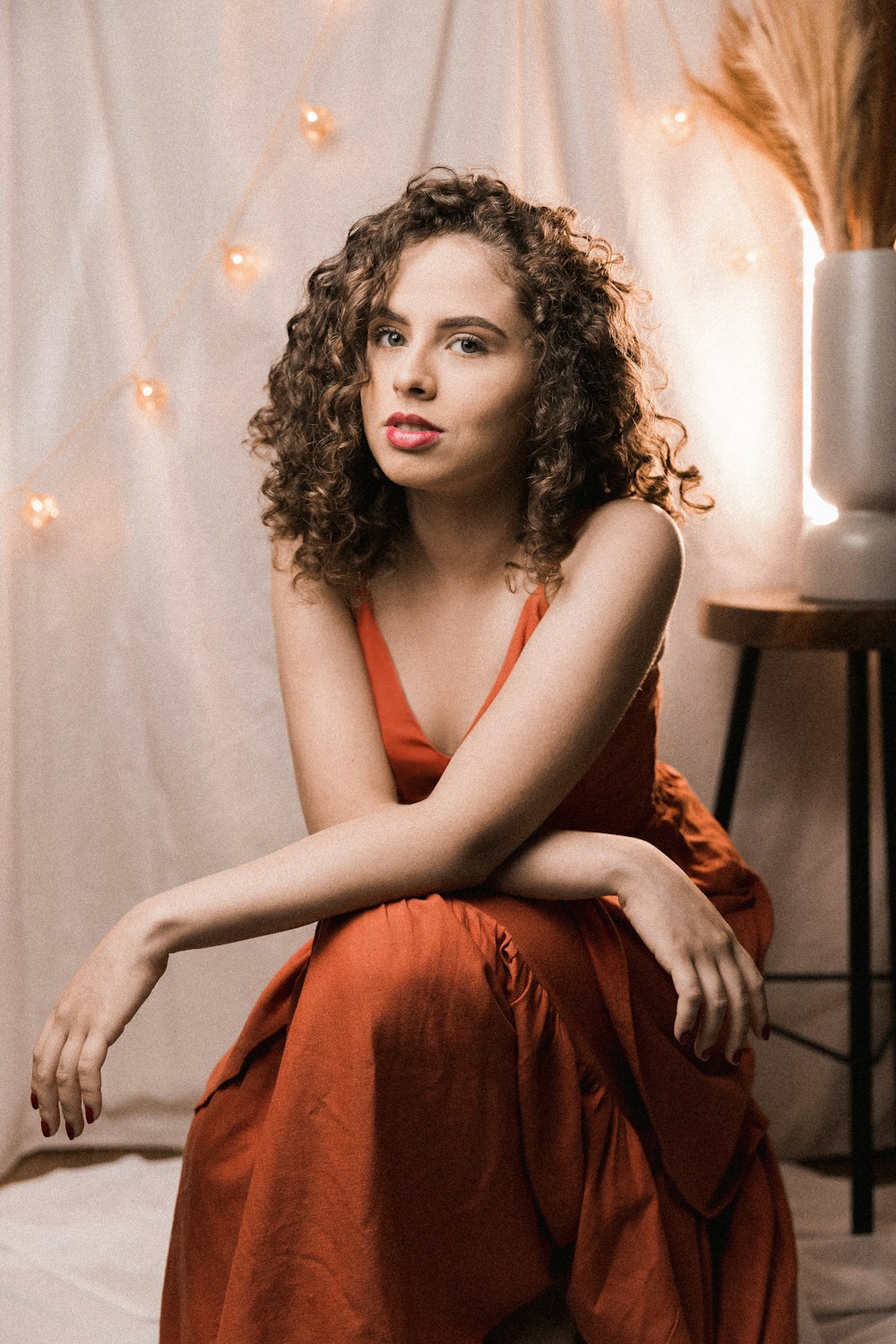 woman in red sleeveless dress sitting on chair