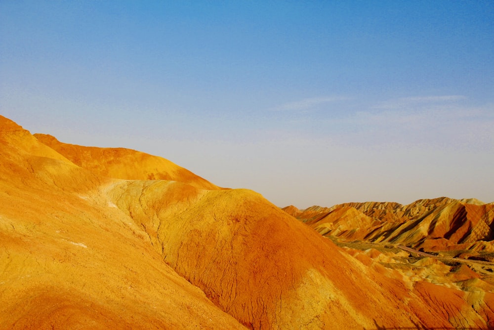 a view of a mountain with a blue sky in the background