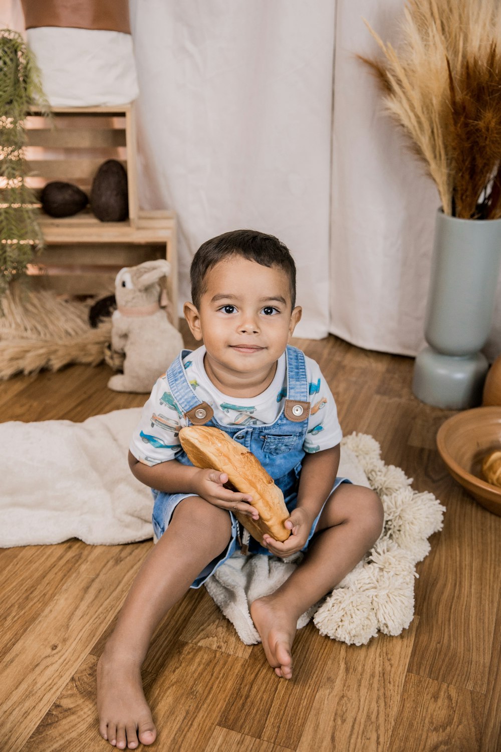 boy in blue and white stripe polo shirt holding sliced bread