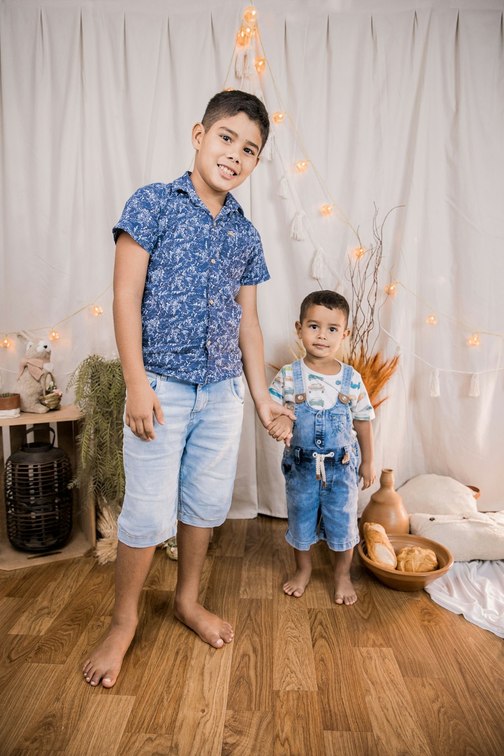boy in blue and white floral button up t-shirt and blue denim jeans standing beside