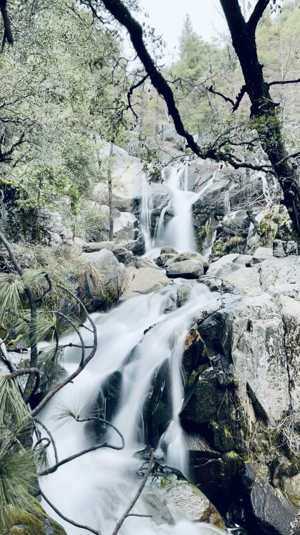 water falls on gray rocky mountain