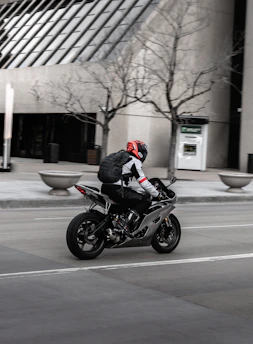 Experienced motorcyclist practicing defensive riding techniques on city streets.