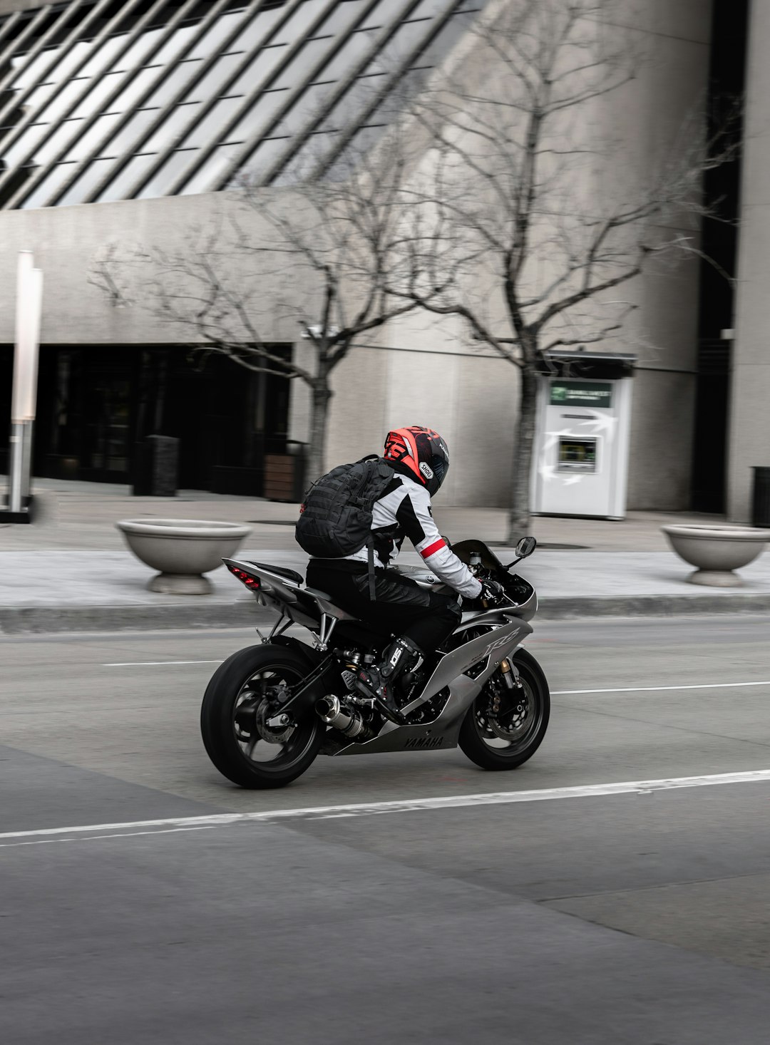 man in black jacket riding motorcycle on road during daytime