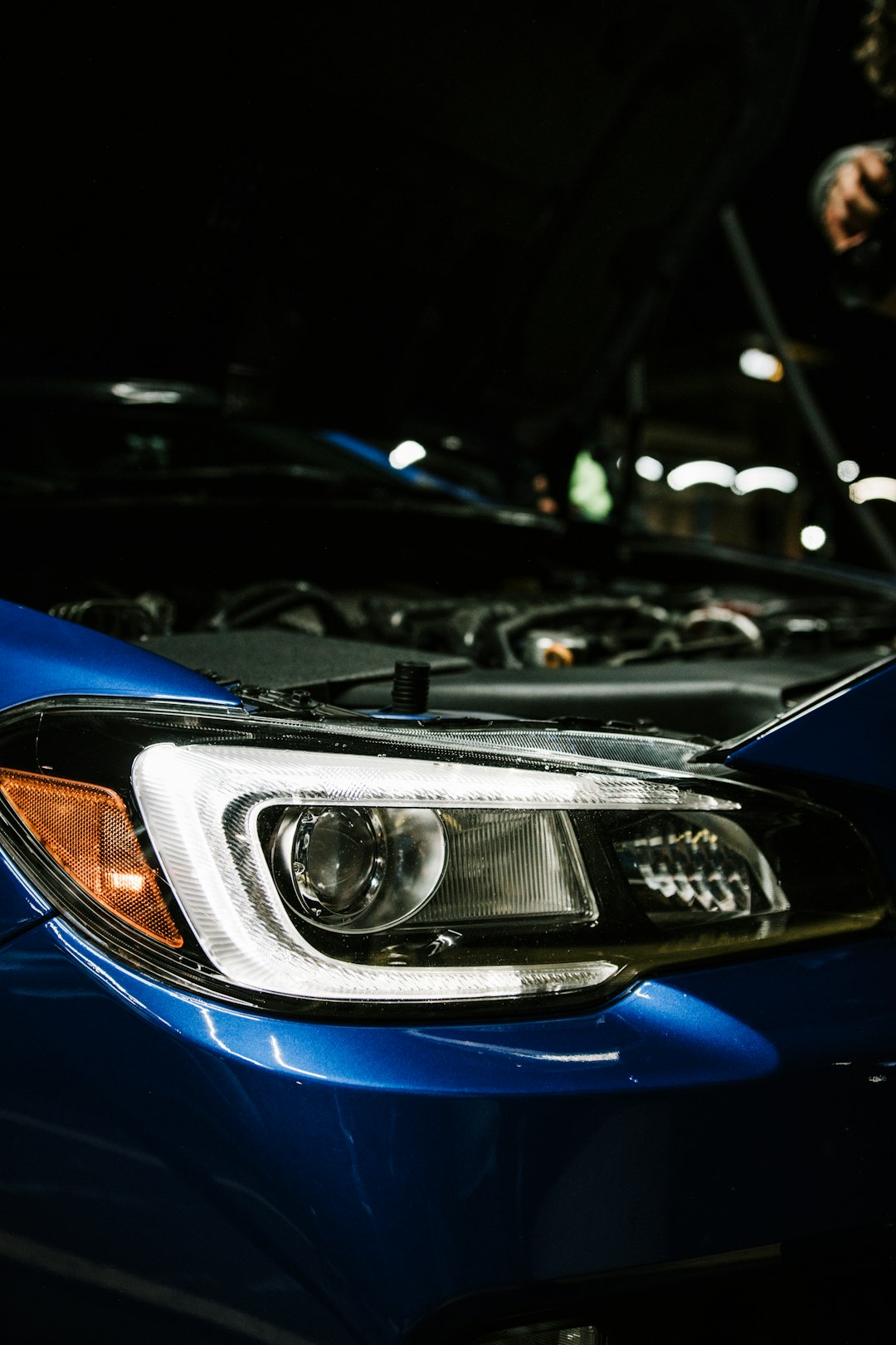 blue car with white and yellow lights