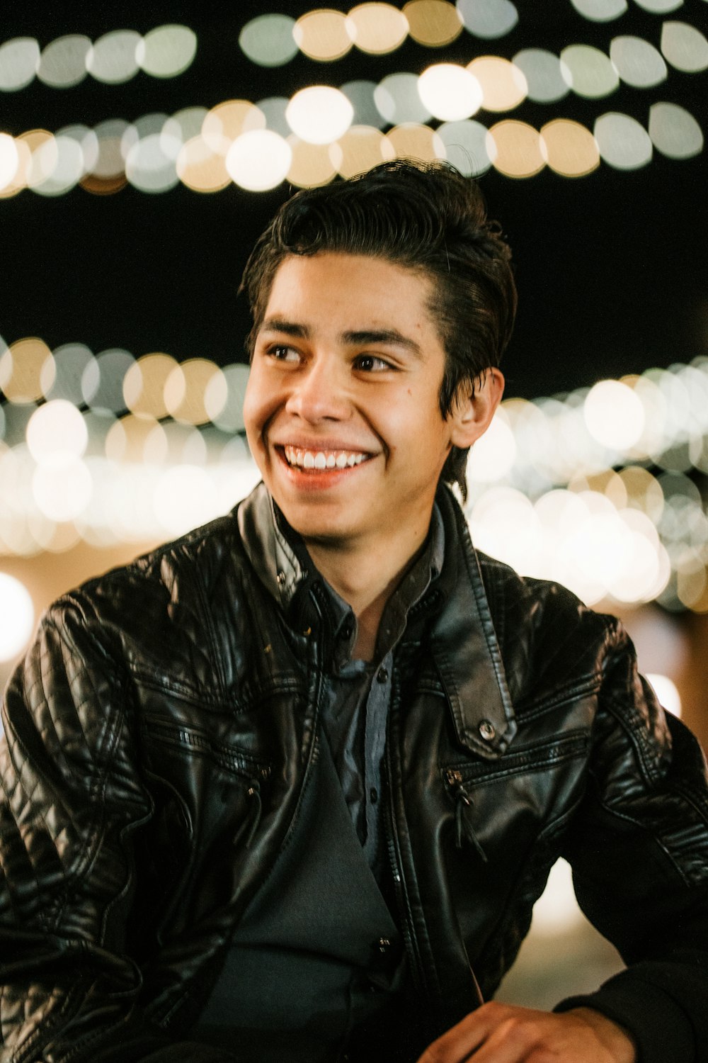 man in black leather jacket smiling