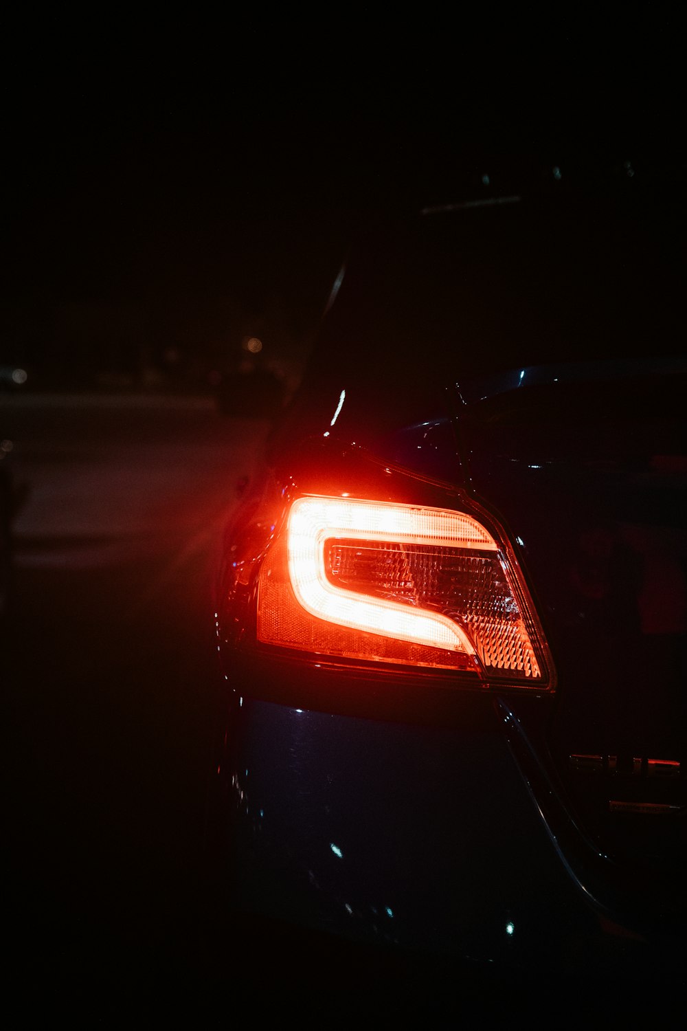 red car on road during night time