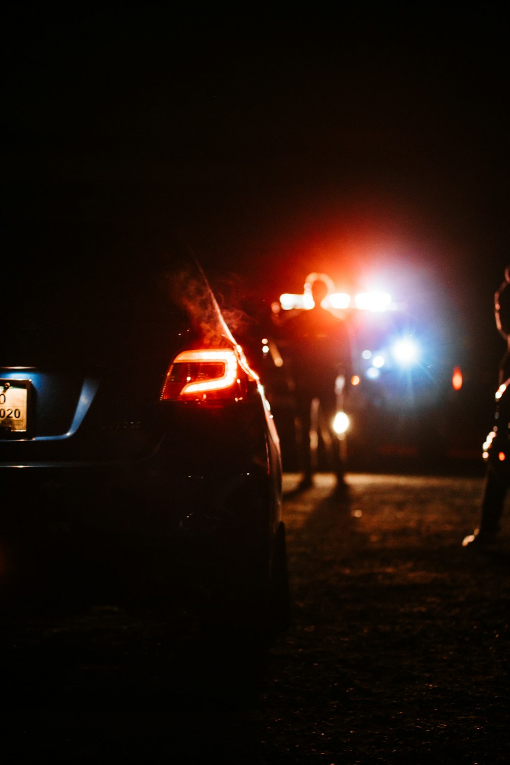 person standing on road during night time