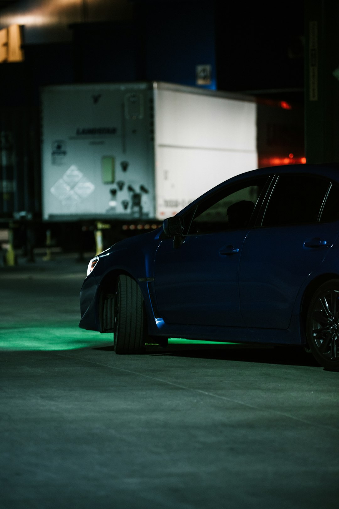 blue sedan on road during daytime