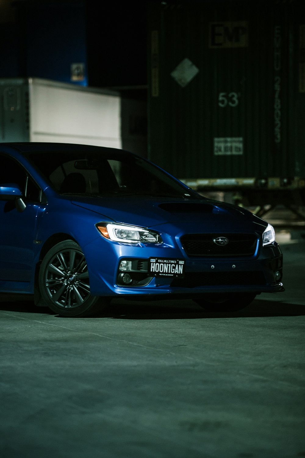 blue honda sedan parked near building