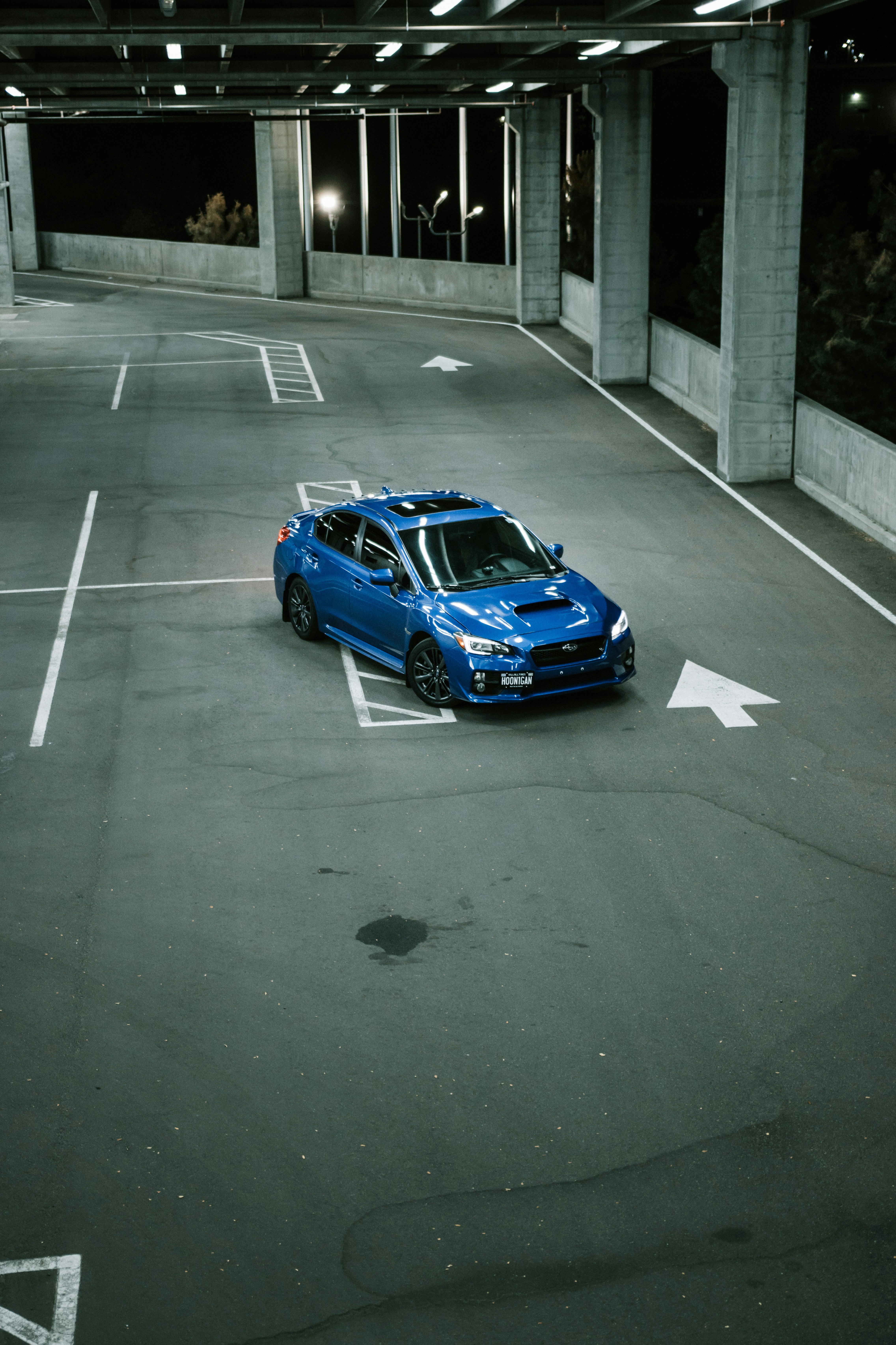 blue sedan on gray asphalt road during daytime