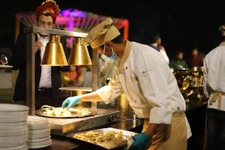 man in white chef uniform cooking
